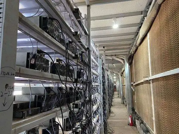 A miner inspecting the operation of his mining rig.